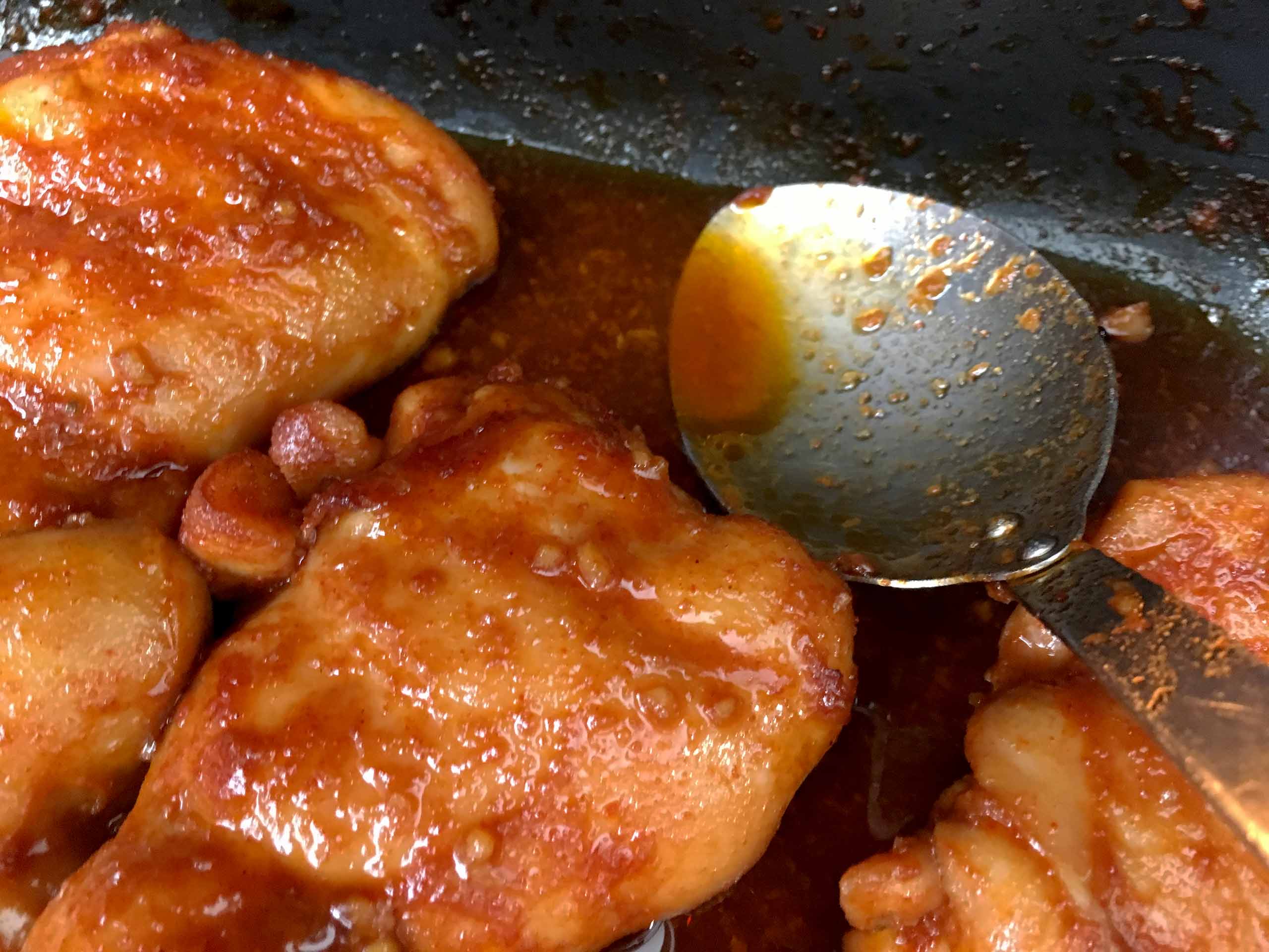 caramelizing the sauce of the spicy honey garlic chicken thigh