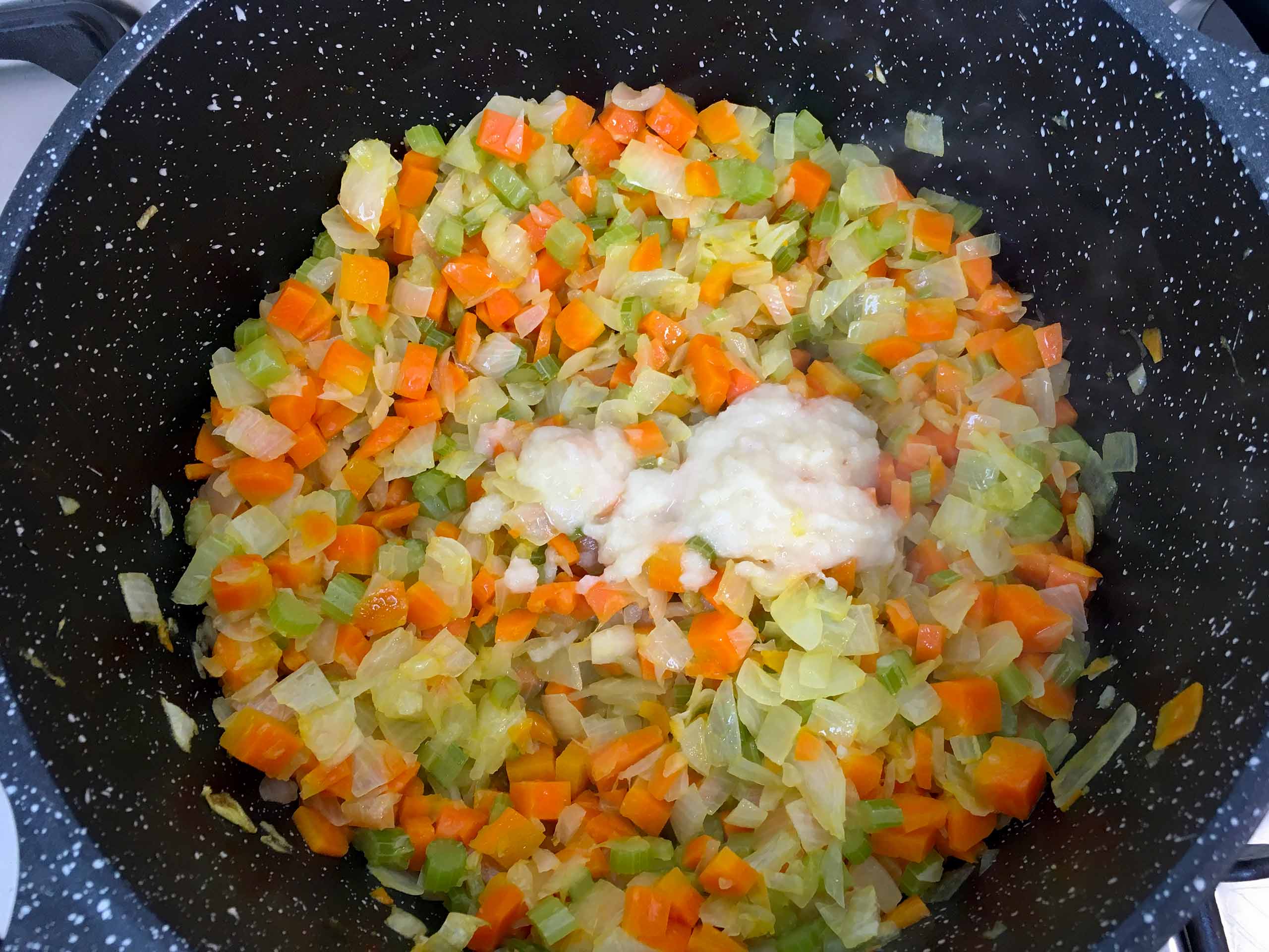 Add the garlic to the vegetables - bolognese sauce