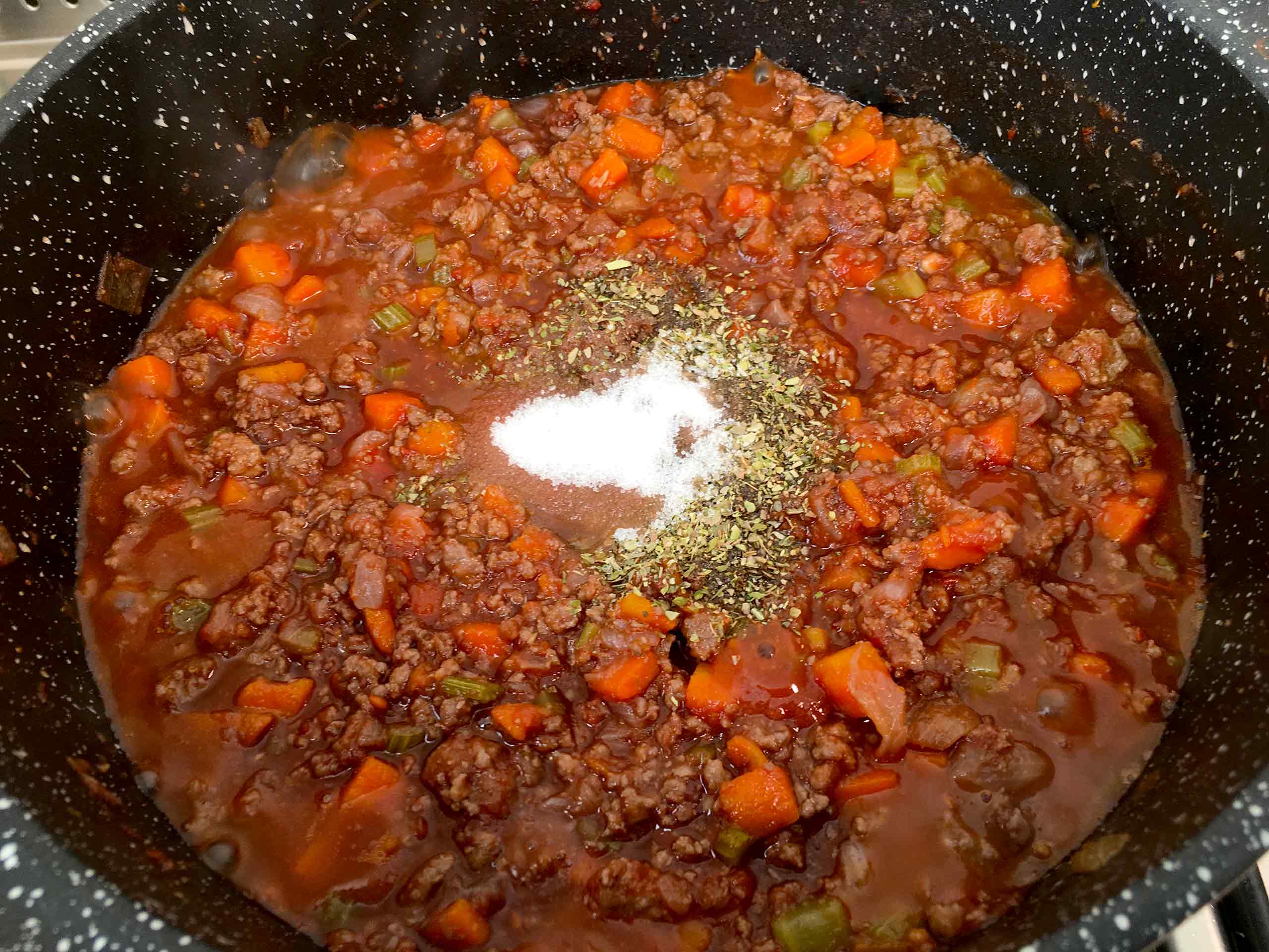 add thesalt, pepper, sugar and oregano to the bolognese sauce