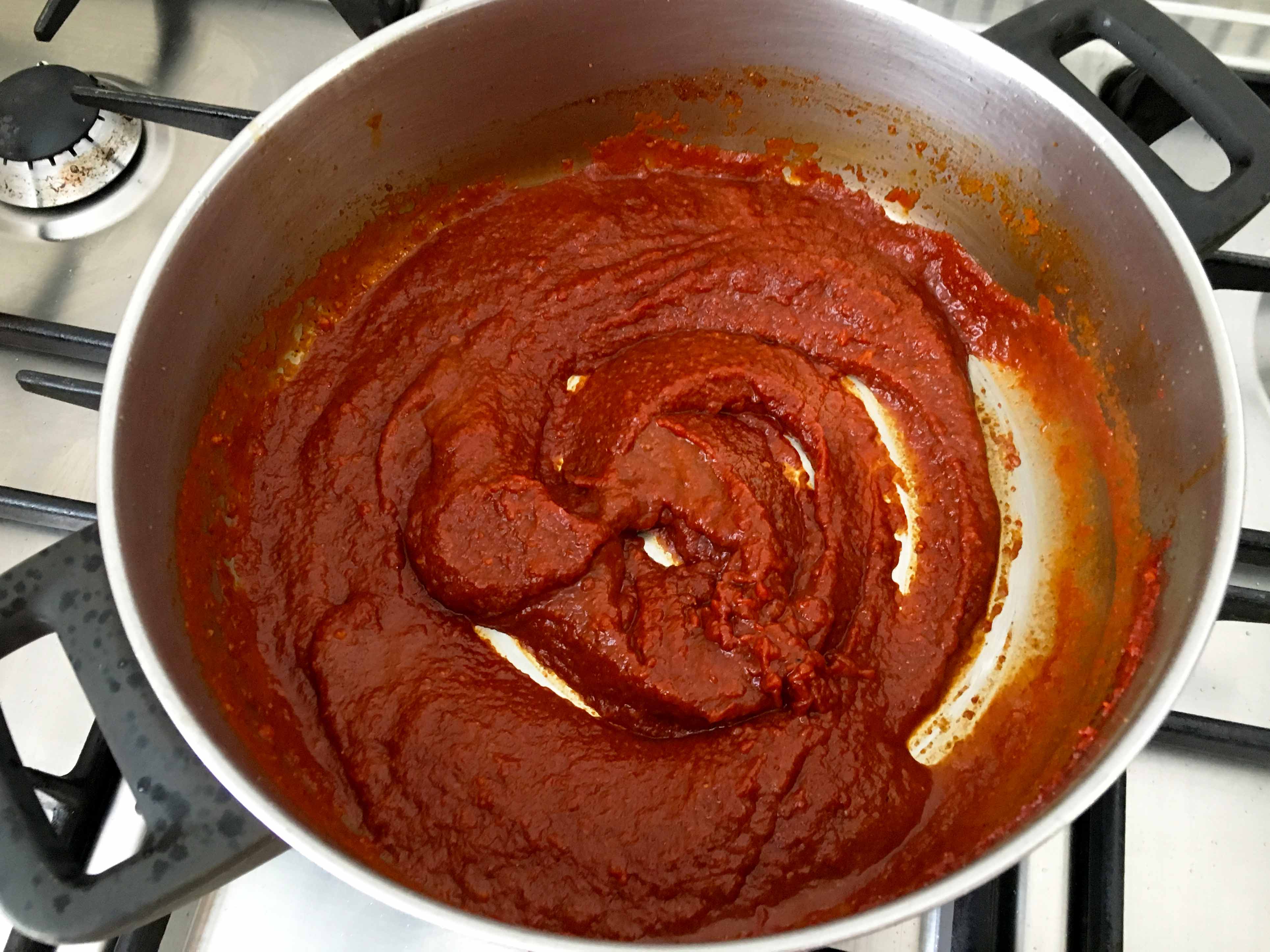 add water to the tomato concentrate - chraimeh fish in tomato hot sauce