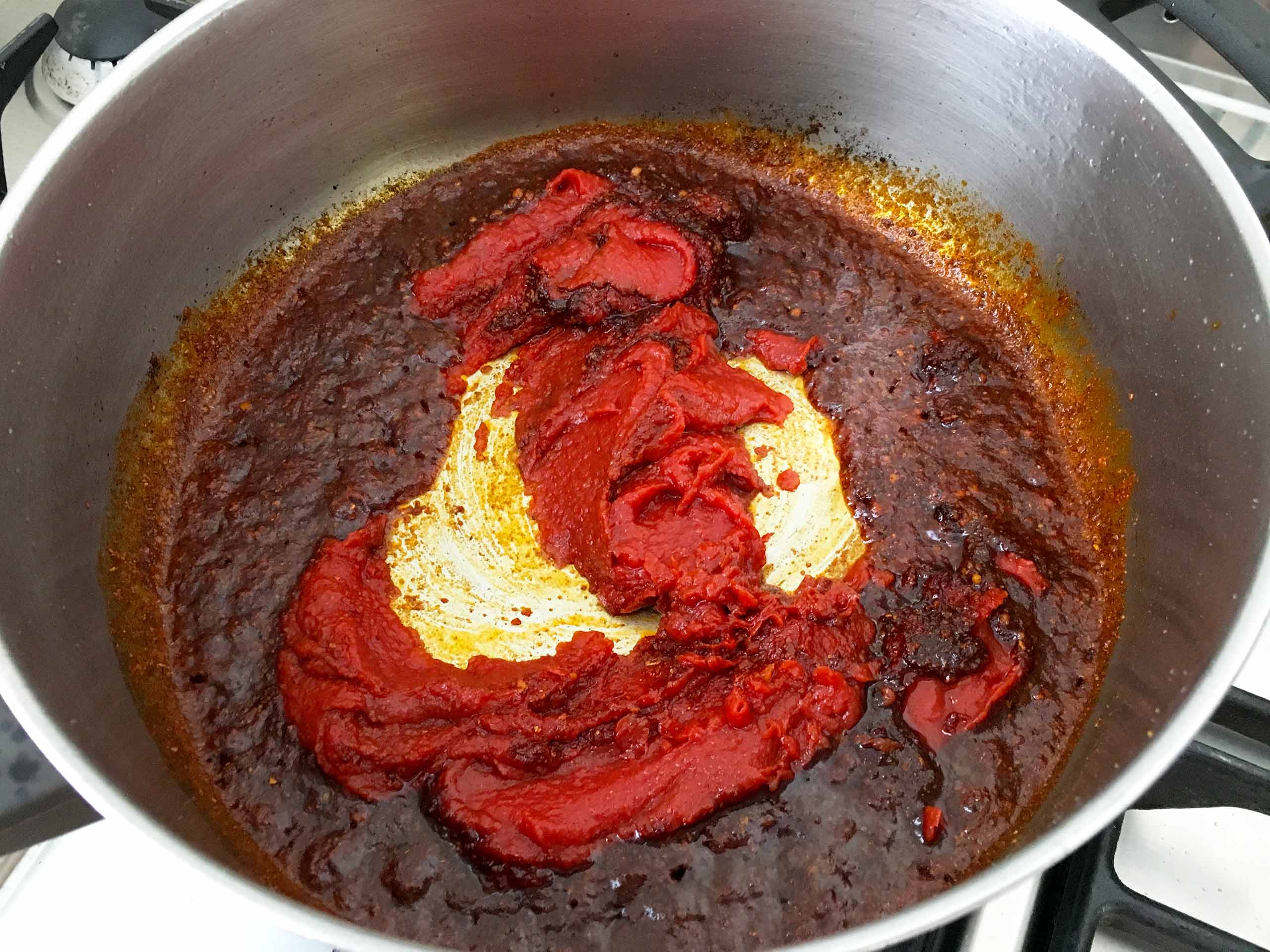 Add the tomato concentrate to the spices Chraimeh fish in a spicy tomato sauce