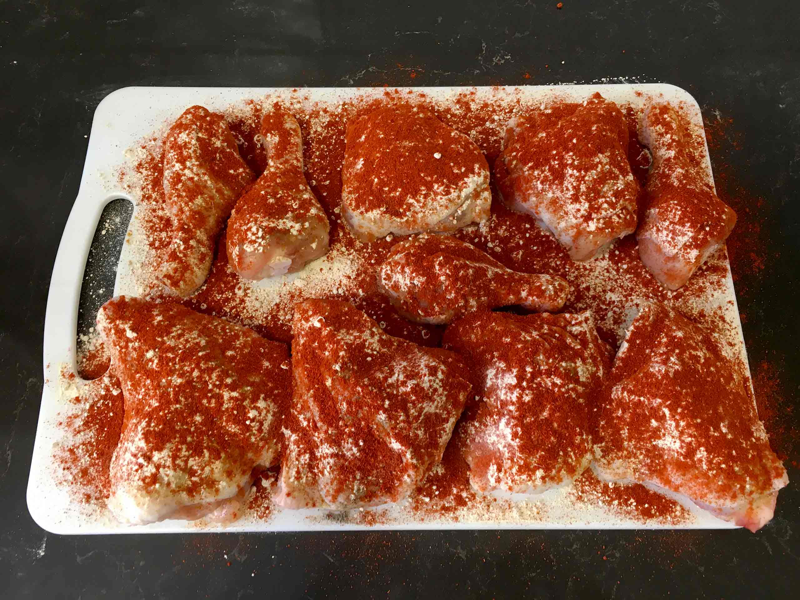 Season the chicken with a nice layer of sweet paprika. be generous.