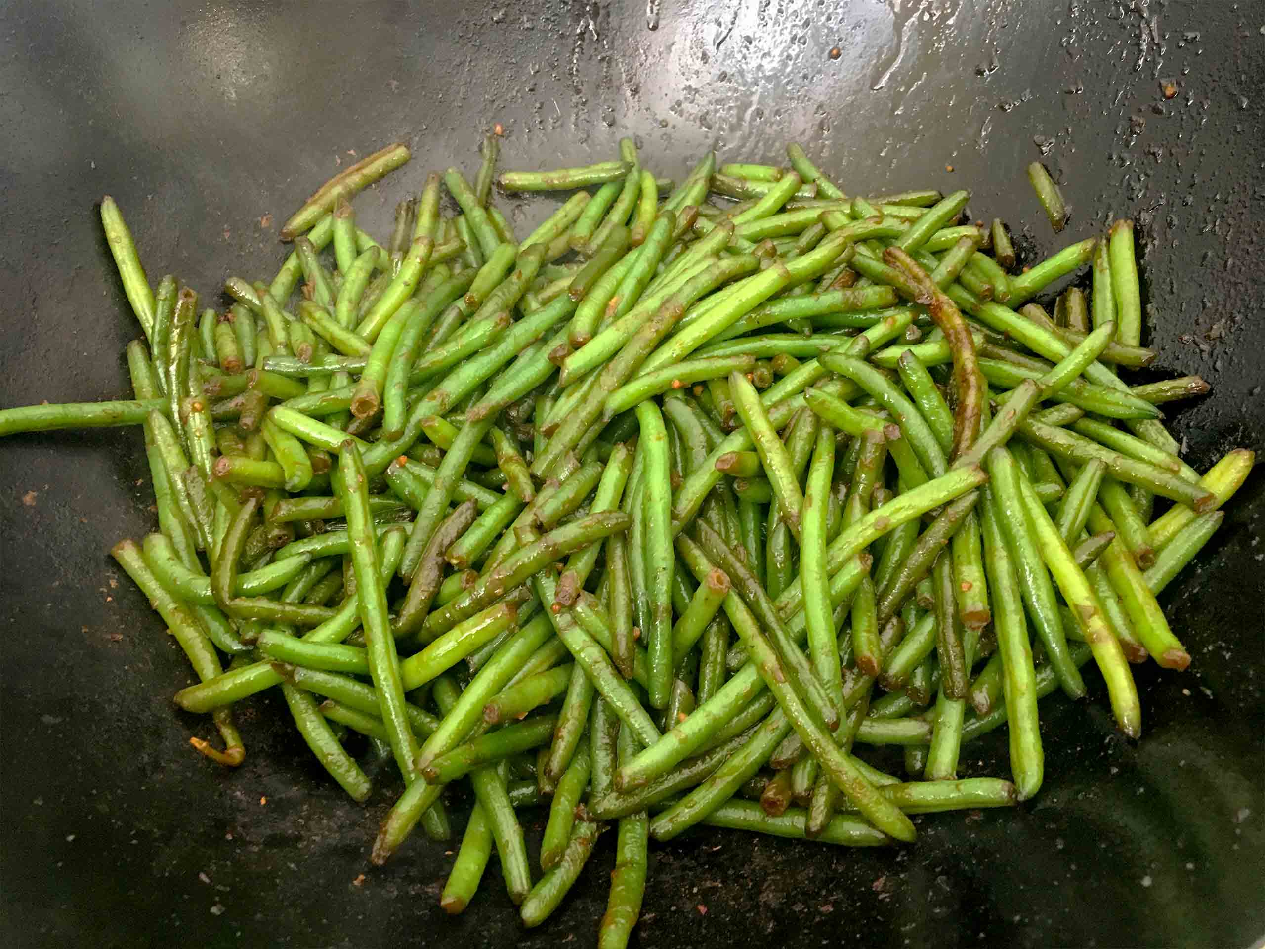 Add the soy sauce to the green beans.