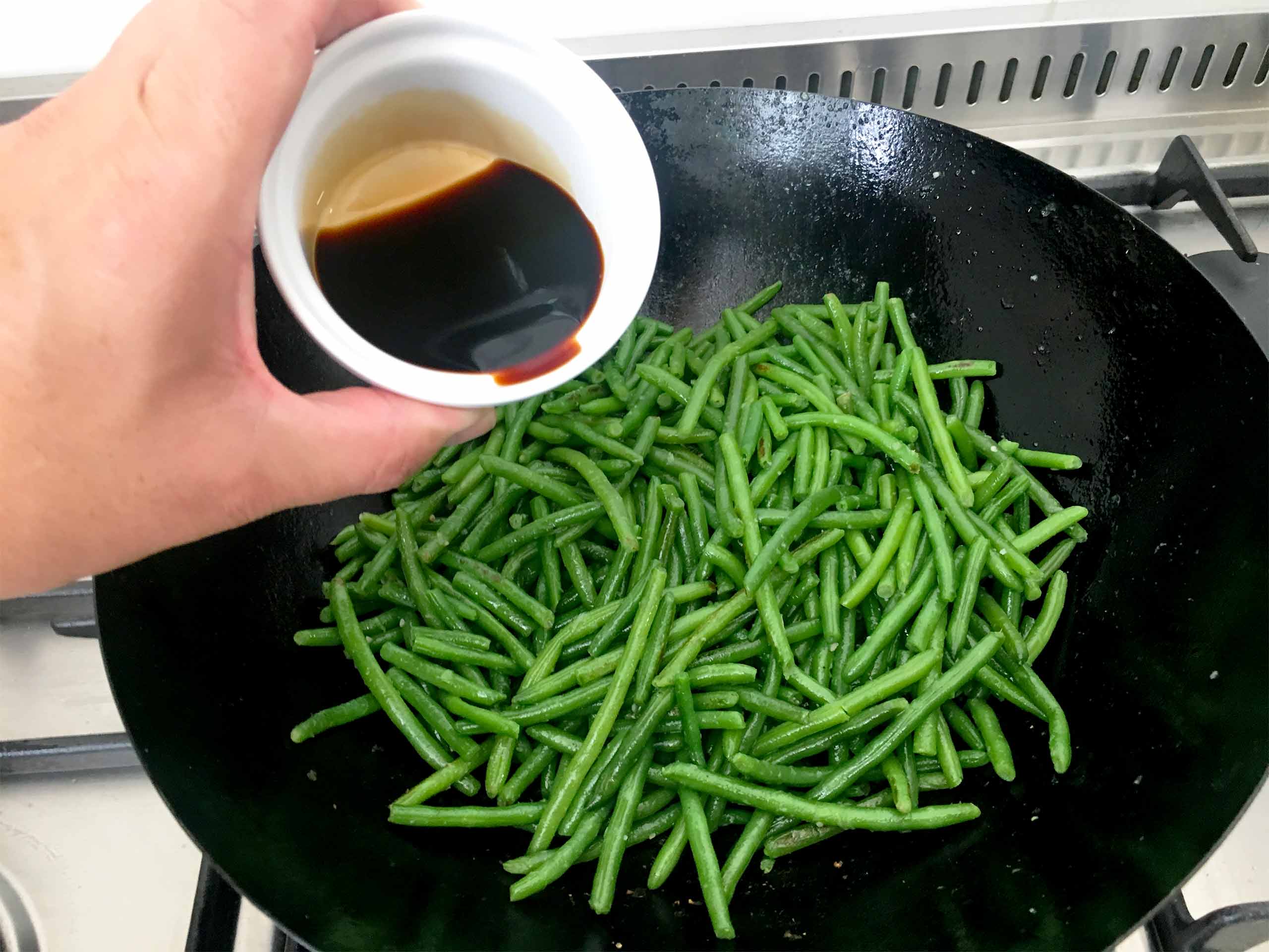 Green beans in soy sauce in the wok