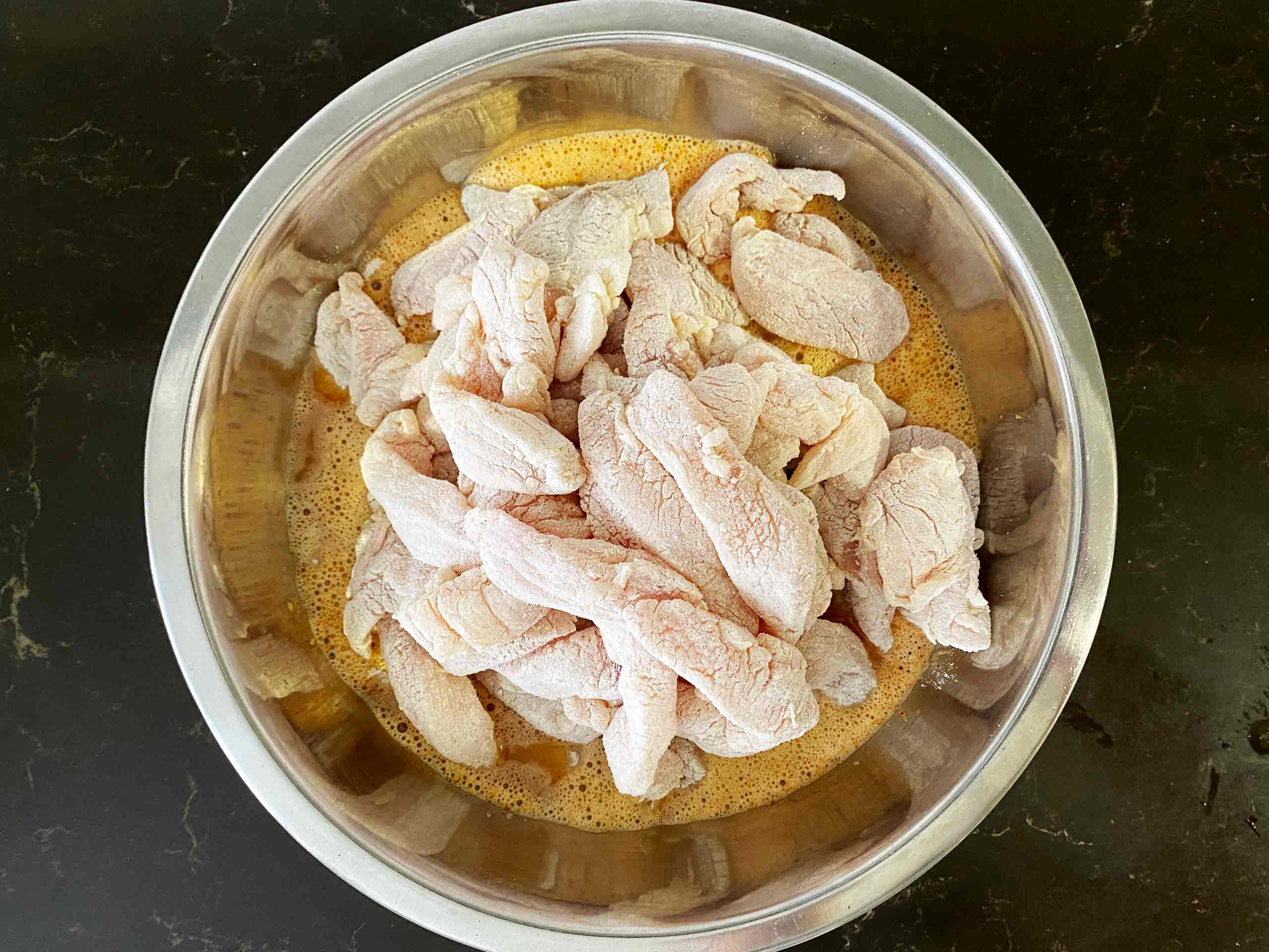 Transfer the floured chicken breast to a bowl with the egg batter.