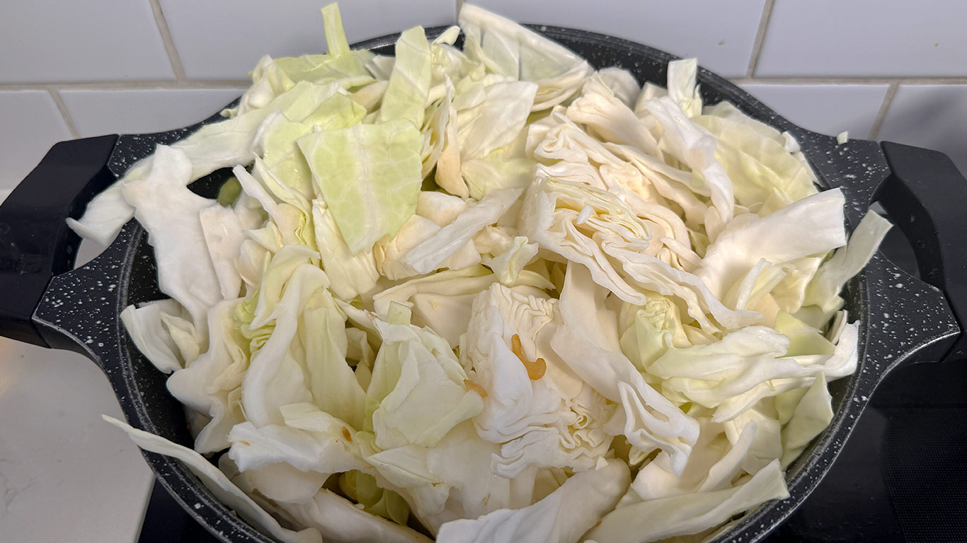 Shredded cabbage added to the pot