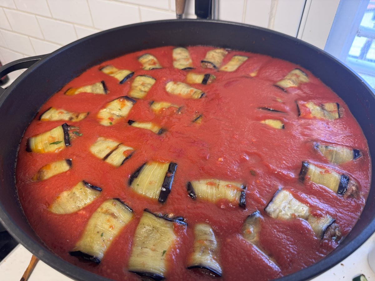 Eggplant rolls arranged in tomato sauce