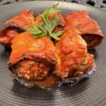 Eggplant rolls stuffed with meat in tomato sauce