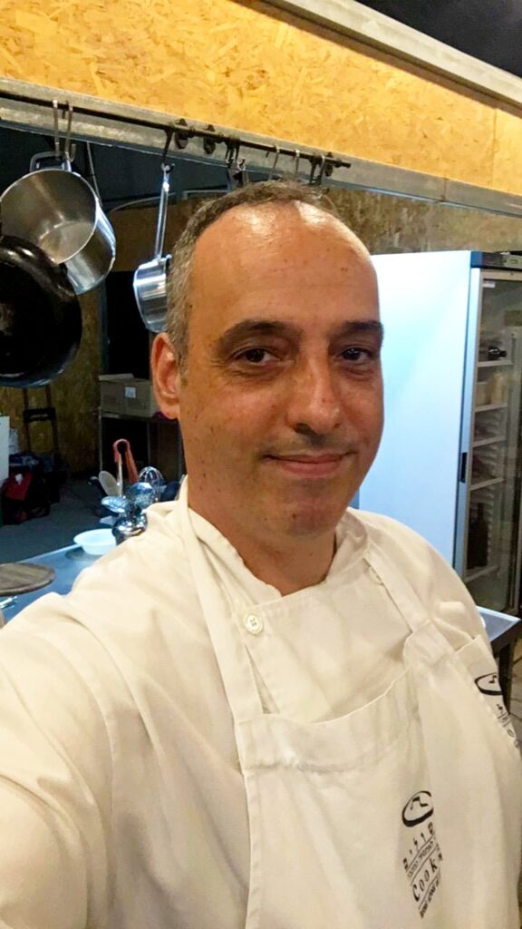 Hanan Evyasaf in a chef jacket in his home kitchen