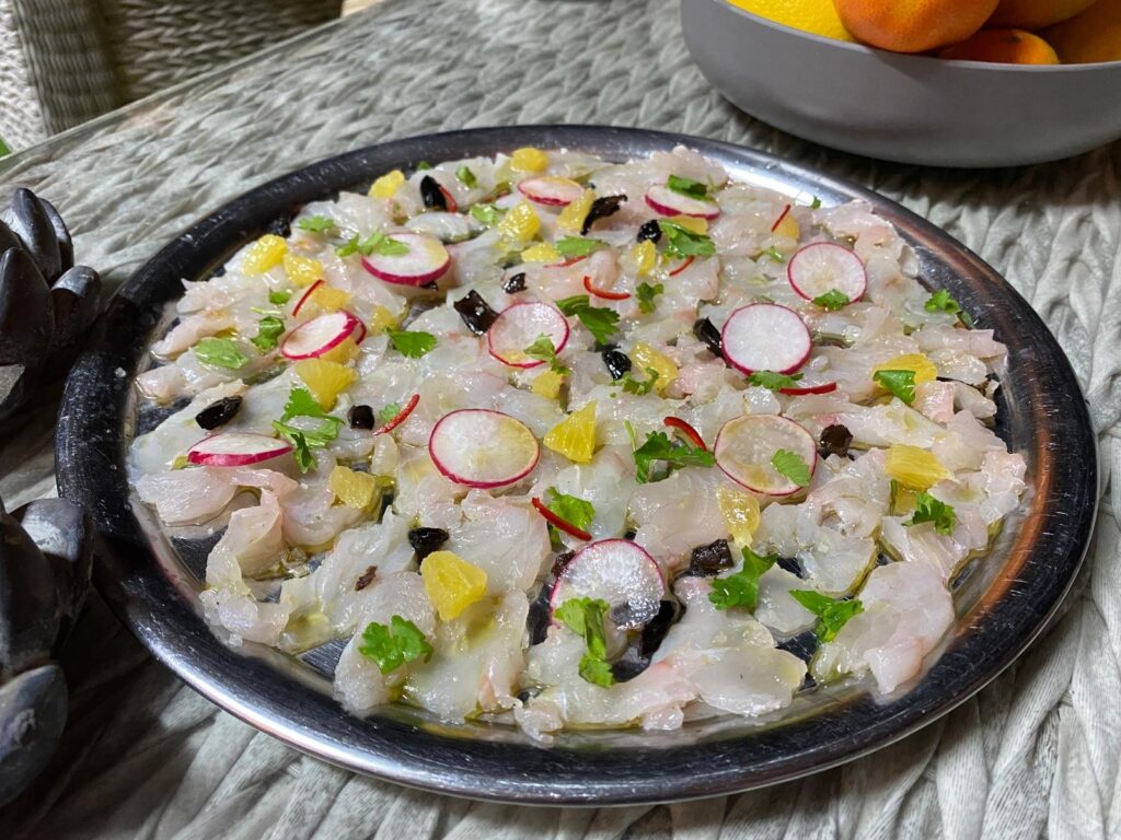 Shrimp carpaccio with radish, citrus and herbs